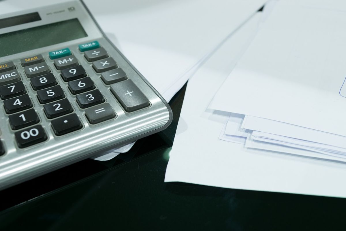 A woman seated in the driver's seat of a truck, ready to hit the road.